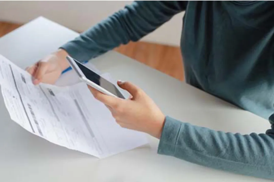 Property owner reviewing tax documents and deadline notice for property tax reduction request Property owner reviewing tax documents and deadline notice for property tax reduction request