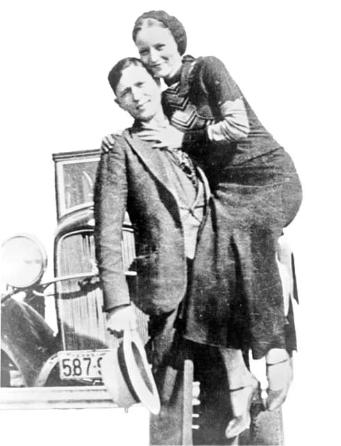 Bonnie Parker and Clyde Barrow, sometime between 1932 and 1934, when their exploits in Arkansas included murder, robbery, and kidnapping. Contrary to popular belief the two never married. They were in a longstanding relationship. Posing in front of a 1932 Ford V8 automobile. Recovered from Bonnie and Clyde after their deaths on May 23, 1934.