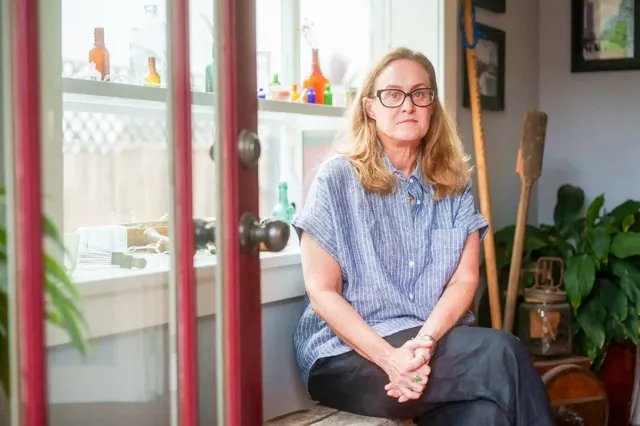 California Health Insurance. Heather Altman, at her Long Beach home on July 11, 2025, worries she won't be able to afford health insurance under the newly approved GOP budget bill. Credit: Photo by Jules Hotz for CalMatters