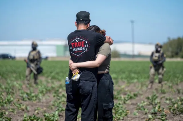 Immigration Raids. Arturo Rangel hugs Judith Ramos whose father works at the greenhouse in the background as federal immigration agents block access during a raid in the agriculture area of Camarillo, Calif., Thursday, July 10, 2025.
