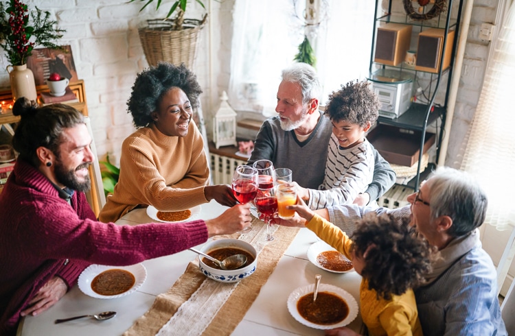 A group of people cheersing around a table