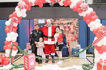 Santa and Val Verde Police Officer Max Garcia pose with a recipient family of Christmas gifts in the 5th Annual Chief’s Toy Chest, hosted by the Val Verde Unified School District Police Department.