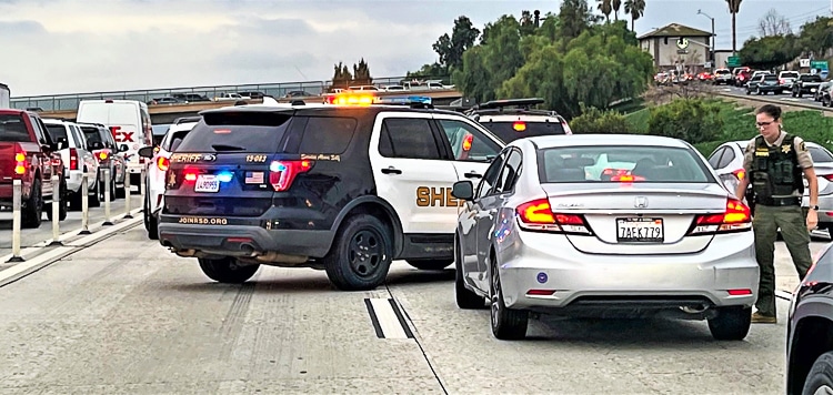 Riverside Sheriff’s and California High Patrol officers block off the southbound 15 traffic just north of the 6th Street overpass in Norco, about a half-mile from the final shoot-out in which Deputy Cordero’s assailant was shot dead.