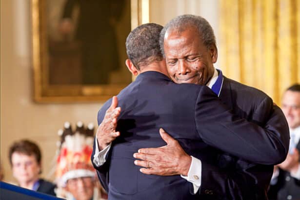 The late Oscar Award-Winning Actor Sidney Poitier hugs President Barack Obama upon receiving the Presidential Medal of Honor in 2009
