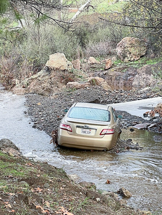 CAr stuck in a river during califorina flooding January 2023