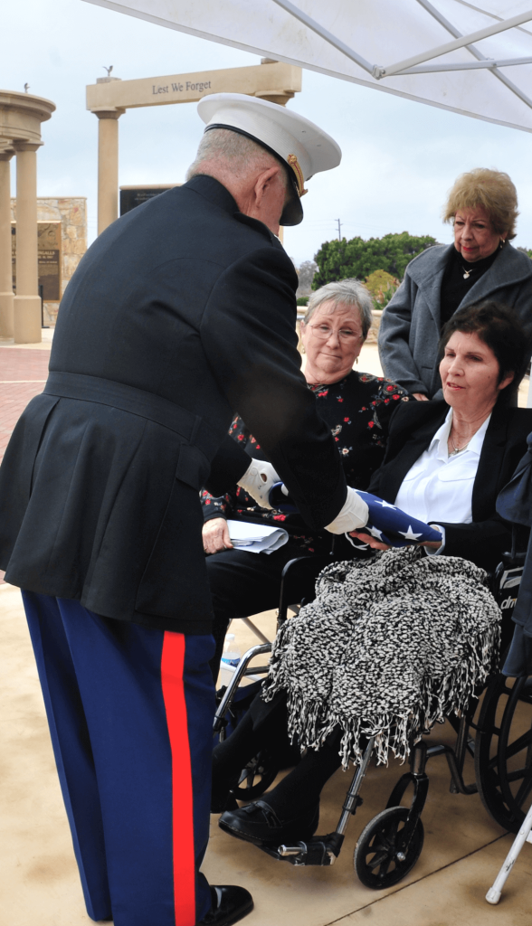 U.S. Marine Lt. Col. (ret.) Bill Schwab presents Jean Hoffman, the widow of the late Norco City Councilman Ted Hoffman, an American flag, emblematic of Hoffman's service in the military during the Vietnam War. Hoffman died at the age of 70 last month.