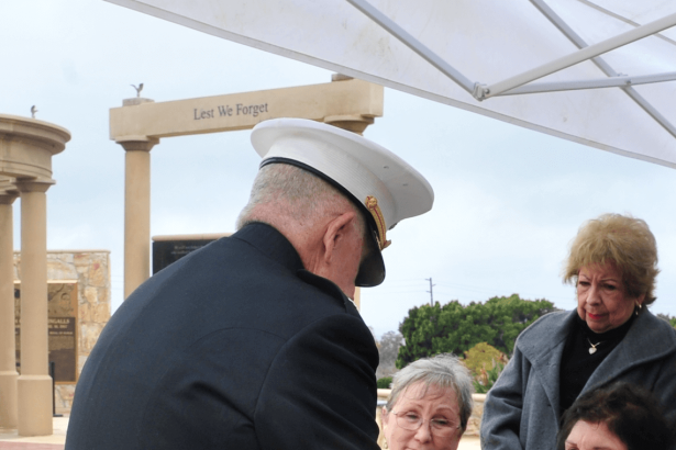 U.S. Marine Lt. Col. (ret.) Bill Schwab presents Jean Hoffman, the widow of the late Norco City Councilman Ted Hoffman, an American flag, emblematic of Hoffman's service in the military during the Vietnam War. Hoffman died at the age of 70 last month.