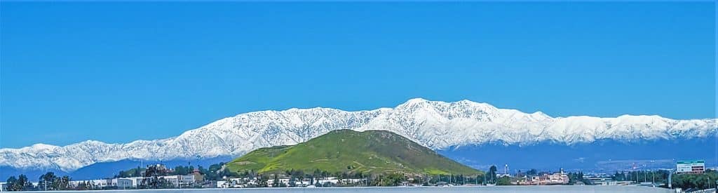 Snow packed San Gabriel Mountains frame the IE as seen from I-15 near Norco. More storms expected Friday and next week. Photo by Gary Evans.