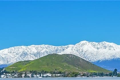 Snow packed San Gabriel Mountains frame the IE as seen from I-15 near Norco. More storms expected Friday and next week. Photo by Gary Evans.