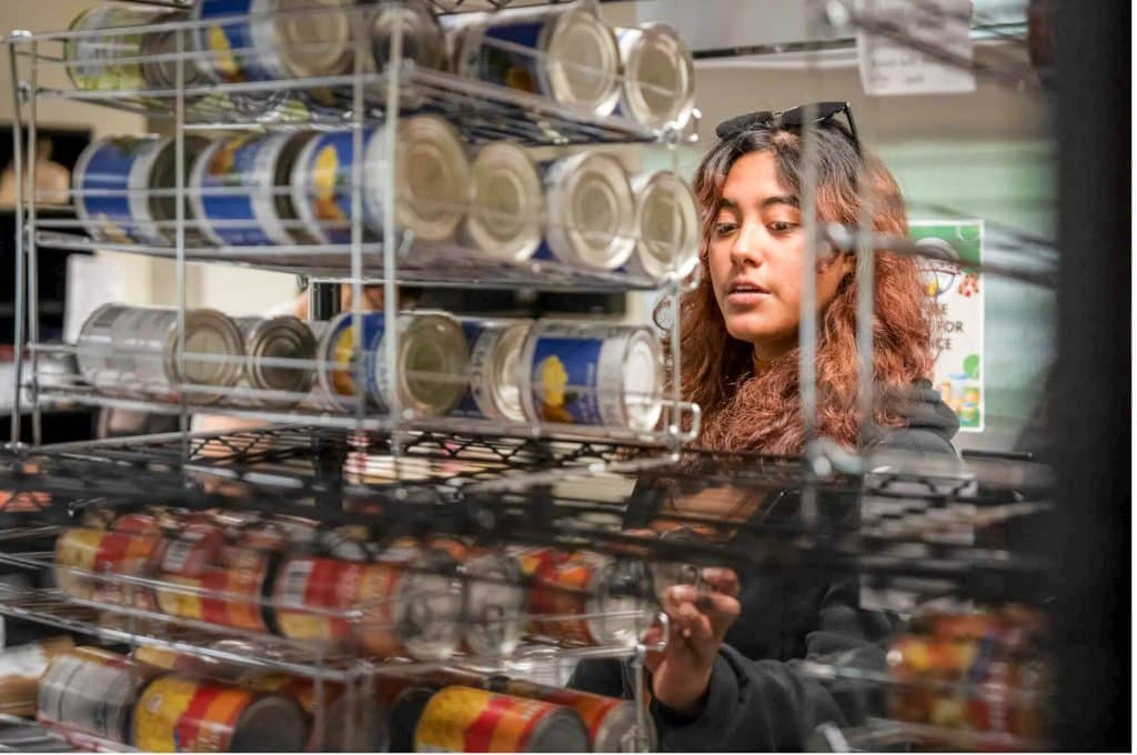 Community Colleges Student Sofia Lopez picks out grocery items at the Basic Needs Program site at Los Medanos College in Pittsburg on May 4, 2023. Credit: Photo by Loren Elliott for CalMatters