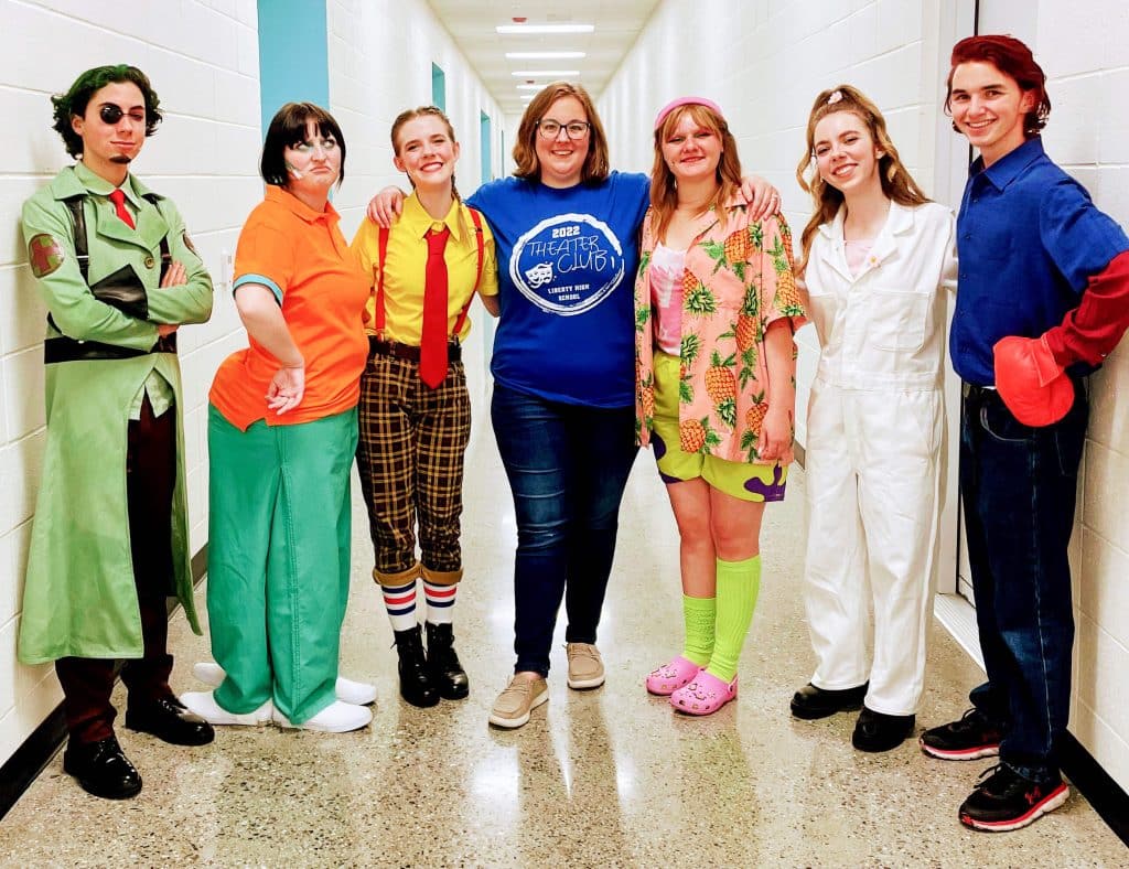 Liberty High Teacher “SpongeBob” Cast Members surround director Chelsea Dove, (L-R) Michael Mirabal (Plankton), Kayli Warner (Squidward), Carly Catiller (SpongeBob), Chelsea Dove (Director), Kamryn Putney (Patrick), Emma Catiller (Sandy) and Dylan Dalton (Mr. Krabs)