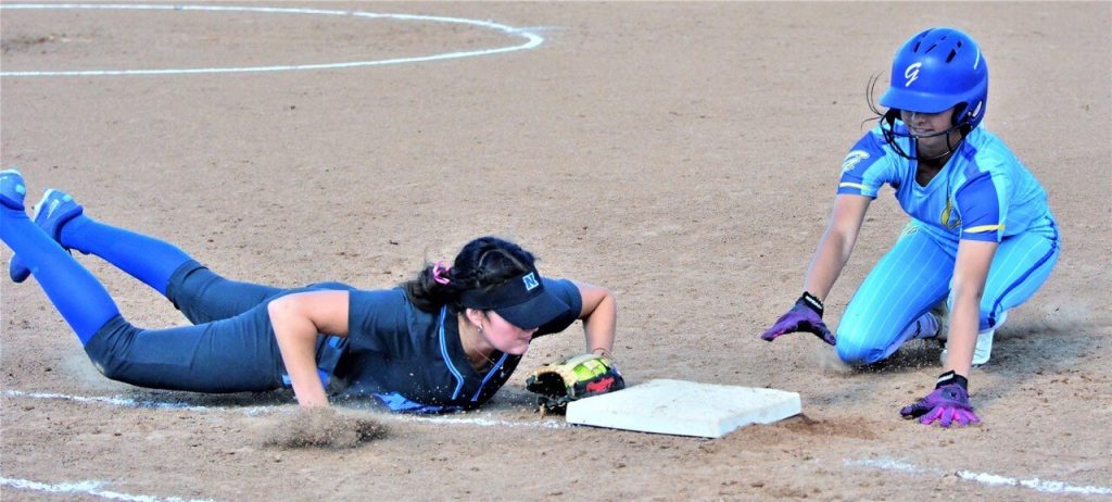 Norco’s Katie Terrazas (left) dives to first and doubles up a Gahr runner after catching a line drive for the first out during the Cougars 9 – 5 first round CIF Division 1 victory over the Gladiators. Credit: Photo by Gary Evans