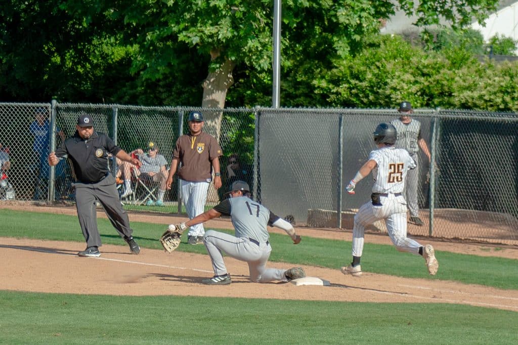 Santiago vs Crespi. Santiago 1st baseman Barrett Ronson is unable to corral a throw in the dirt as Crespi extended its lead to 6-3.