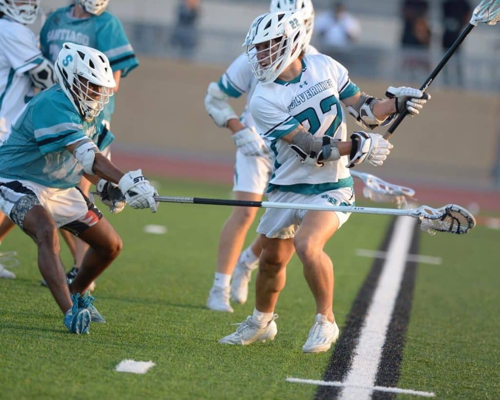 CIF Lacrosse Title. Corona Santiago's Austin Ellis uses his stick to defend against Aliso Viejo's Thomas Smith in CIF Div. 2 lacrosse championship game Saturday. Santiago won, 11-3, at Downey High School.