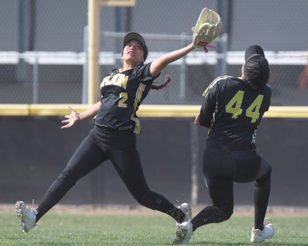 High School Sports Playoffs- Cajon shortstop Salina Guzman avoids a collision with teammate Q'Ella Pickett, catching a pop fly at Santiago, but the Sharks won. Photo by Jerry Soifer