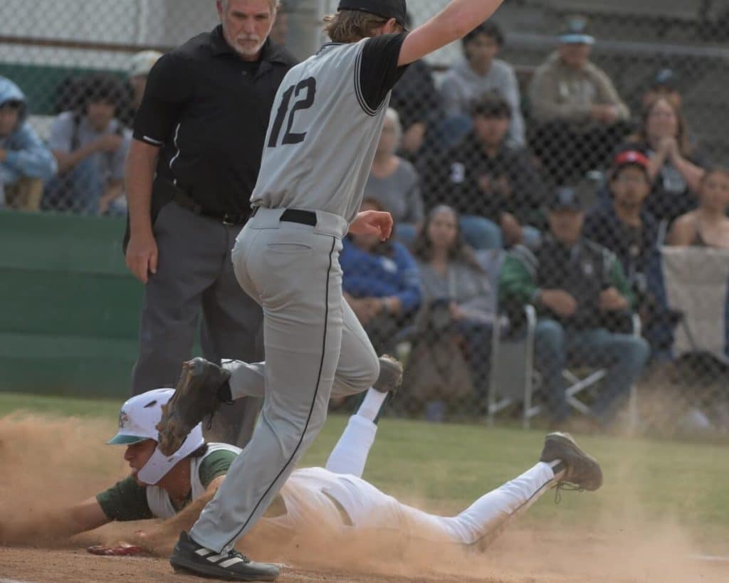 Fontana Kaiser’s Daniel Inzunza slides into home on a wild pitch as Corona Santiago's Nick Lewis covers. Santiago won the first-round game, 6-5. Credit: Photo by Jerry Soifer