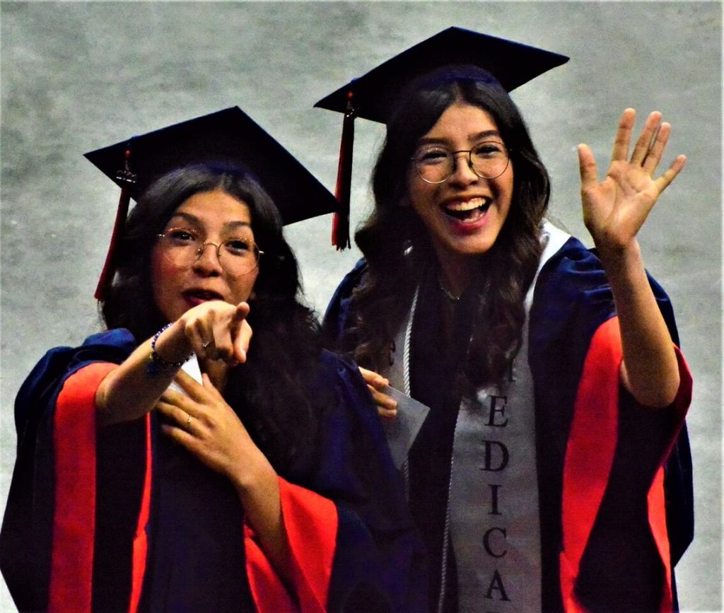 Twins Arianna and Arlenne Quiroz find family members in the Toyota Arena in Ontario during the Eastvale Roosevelt Class of 2023 Commencement Ceremony. 