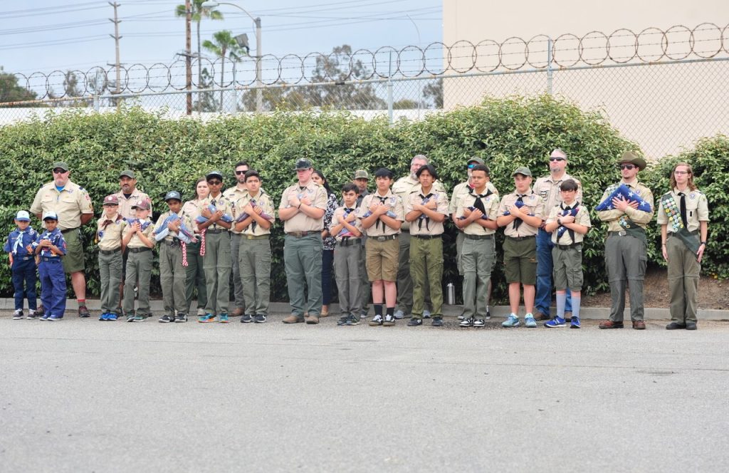 Corona Observes Flag Day. Boys Scouts and Cub Scouts salute during Flag Day ceremony Saturday at the Corona Fire Training Center. Credit: Photo by Jerry Soifer