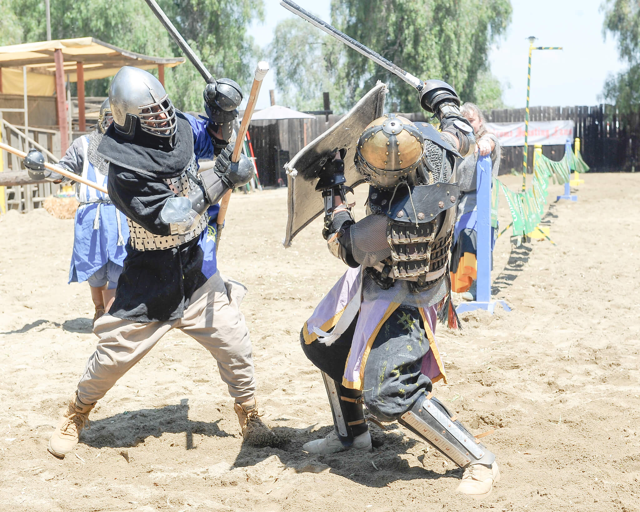 Two knights in armor on horseback fighting a duel with lances in a