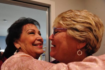 Former Corona City Councilwoman Yolanda Carrillo shows her joy Wednesday as she receives a hug from Corona Planning Commissioner Karen Alexander at the dedication of the renovated shelter. Photo by Jerry Soifer