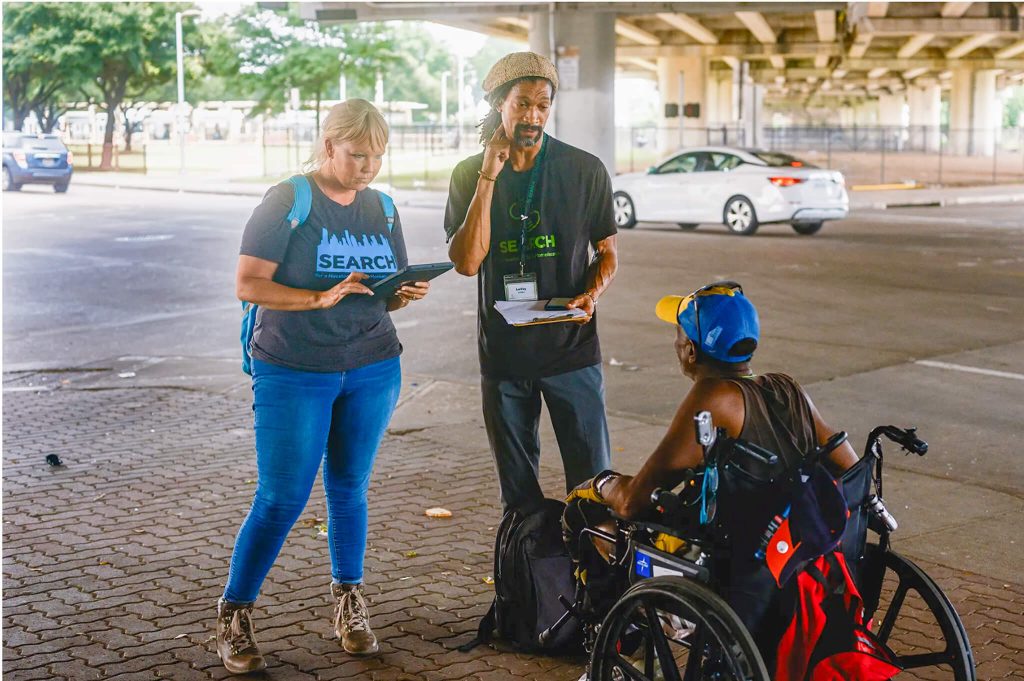 Allison Hillman, left, and LaVoy Darden, right, with Search Homeless Services speak with a client about potential future housing in Houston, Texas.
Credit: Photos by Jordan Vonderhaar for CalMatters
