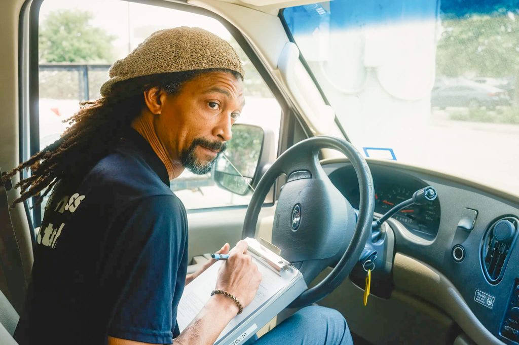 LaVoy Darden with Search Homeless Services drives through his service area looking for clients in Houston, TX. 
Credit: Photo by Jordan Vonderhaar for CalMatters
