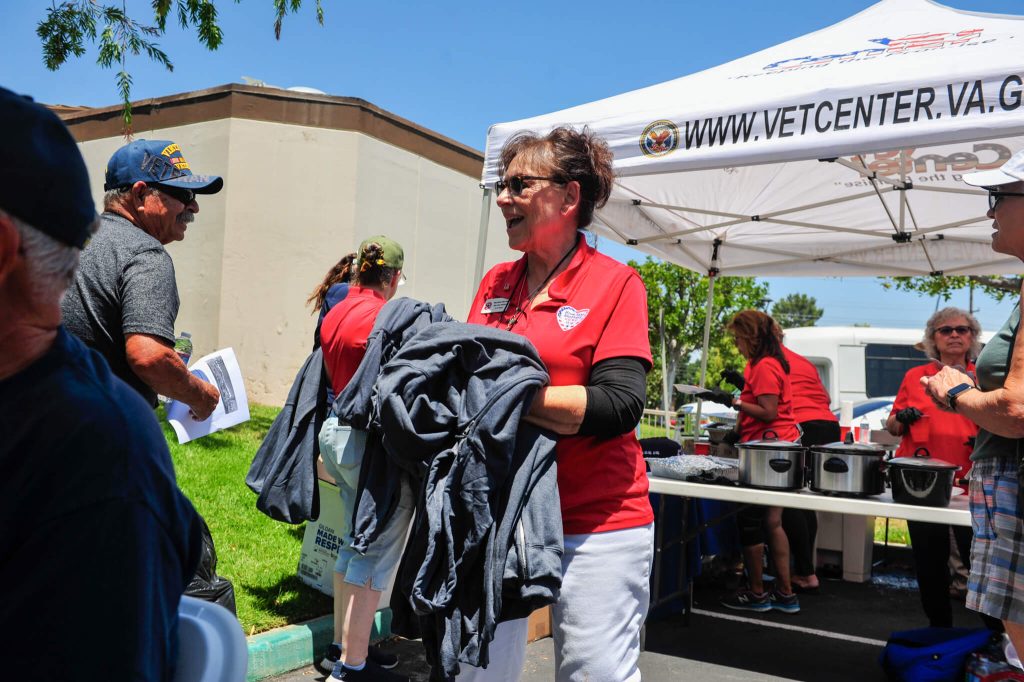 100 Veterans Honored in Corona Friday. Blue star mother MaryAnn Sherman who helped organize Friday's event honoring veterans passes out sweatshirts to the more than 100 in attendance.