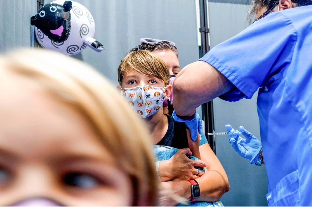 Covered California. Finn Washburn, 9, receives the COVID-19 vaccine in San Jose as his sister, Piper Washburn, 6, waits her turn on Nov. 3, 2021. 
Credit: Photo by Noah Berger, AP Photo
