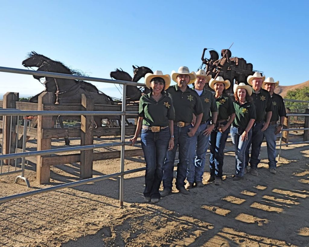 Members of the Norco Mounted Posse Rodeo committee pose by the stagecoach statue at the George Ingalls Equestrian Event Center on the eve of the 37th annual rodeo. From the left are chairwoman Diane Summers, Rick Verduzco, Mike Buelna, Sheila Yanez, Leslie Sandoval, Greg Bowen, and Hector Yanez. The rodeo starts tonight (Aug. 25), continues Saturday, and concludes Sunday.