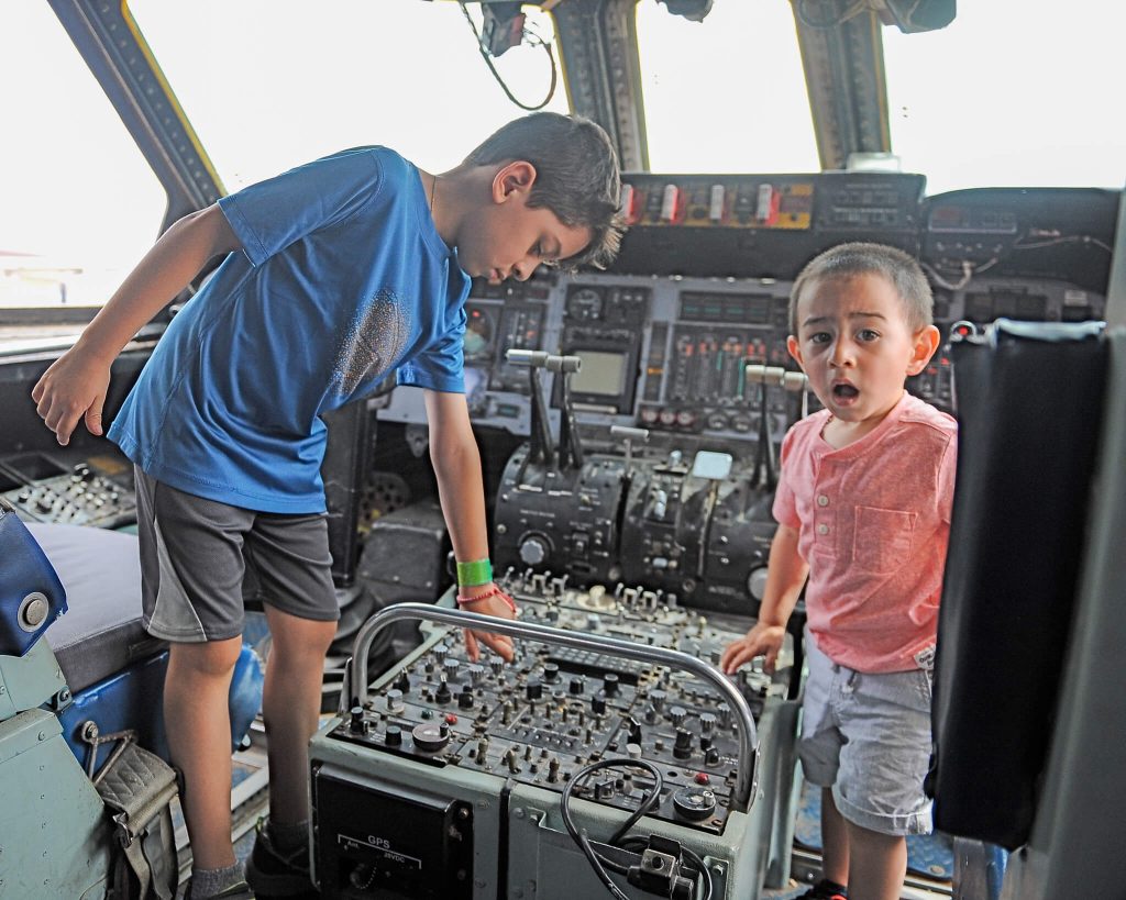 March Air Force Base Open House. Brothers Evan, 6, and Liam Garcia, 2, of Perris, explore the cockpit of the U.S. Air Force C-141 transport