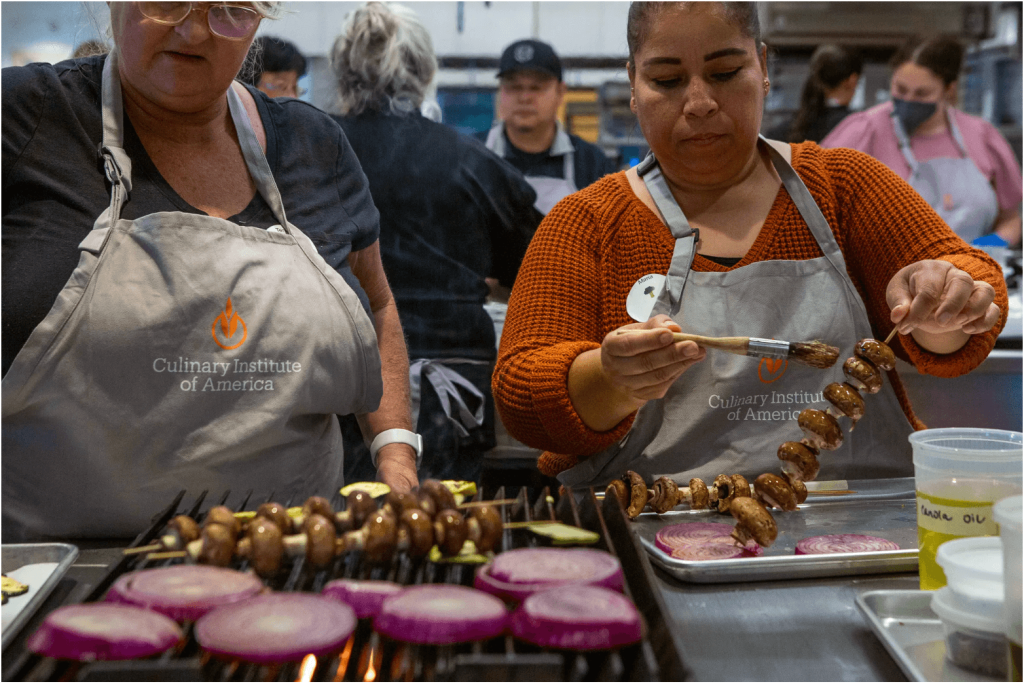 As part of Farm to School, an initiative to provide healthier lunches in California schools, School food service workers at San Luis Coastal Unified School District, Teresa Vigil, left, and Maria Martínez, right, train at the Culinary Institute of America in Napa on Aug. 3, 2023. 

Credit: Photo by Semantha Norris, CalMatters
