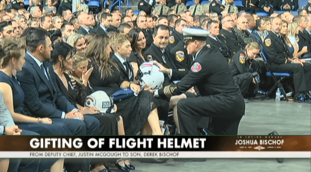 Bischof is presented with his dad's flight helmet, by Cal Fire Deputy Chief Justin McGough
Credit: Cal Fire 
