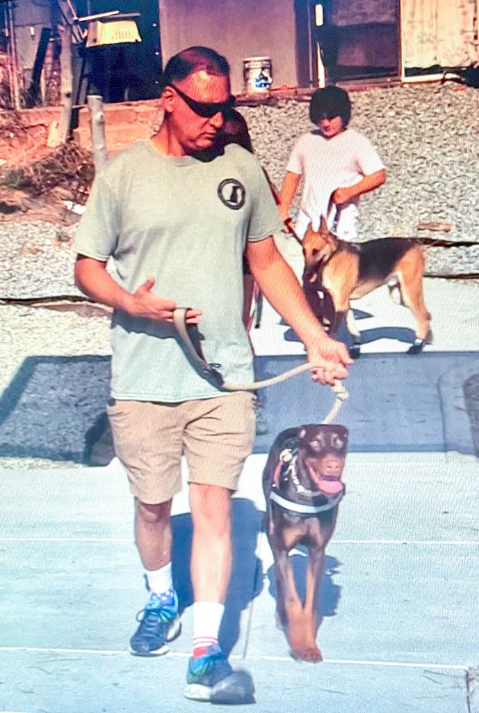 Retired Marine and 4 Paws 4 Patriots trainer John Flores, demonstrates the proper technique for loose leash walking. Credit: Photo by Don Ray