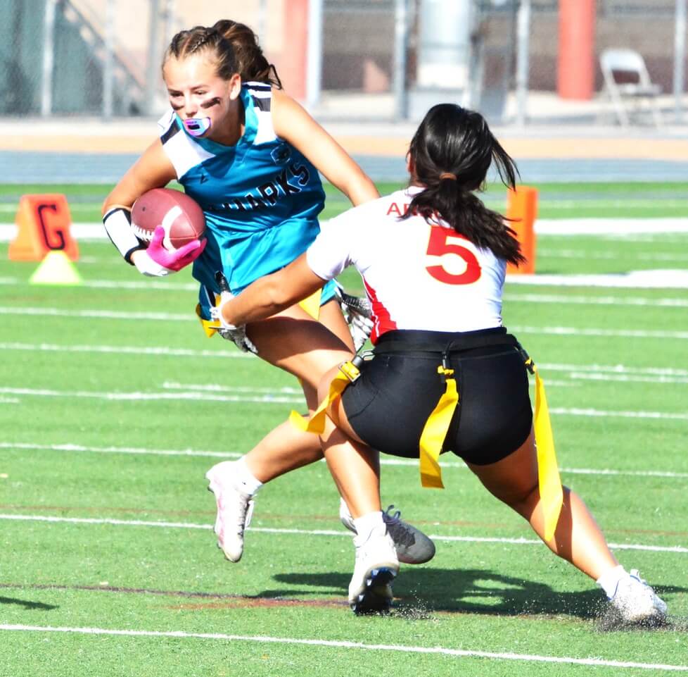 Corona Santiago’s Maddi Saruwatari (left) tries to avoid Corona’s Amy Arellano (5) during the Panthers 20 – 13 victory over the Sharks.
Credit: Photo by Gary Evans
