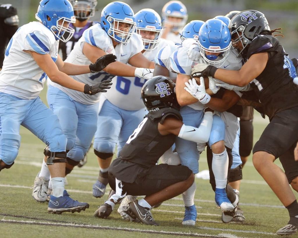 With a swarm of teammates pushing the cause, Norco running back Trevor Schneider fights for yardage.
Credit: Photo by Jerry Soifer
