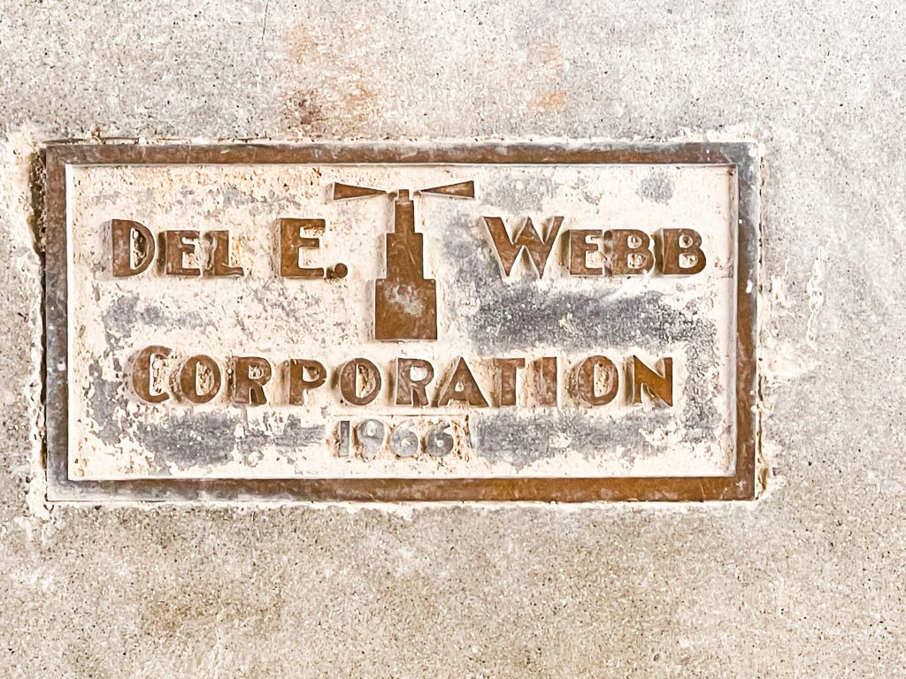Del Webb cement stamp 
Caption: Del Webb placed his custom cement stamp in the entrance to one of the Web Hall entrances. 
