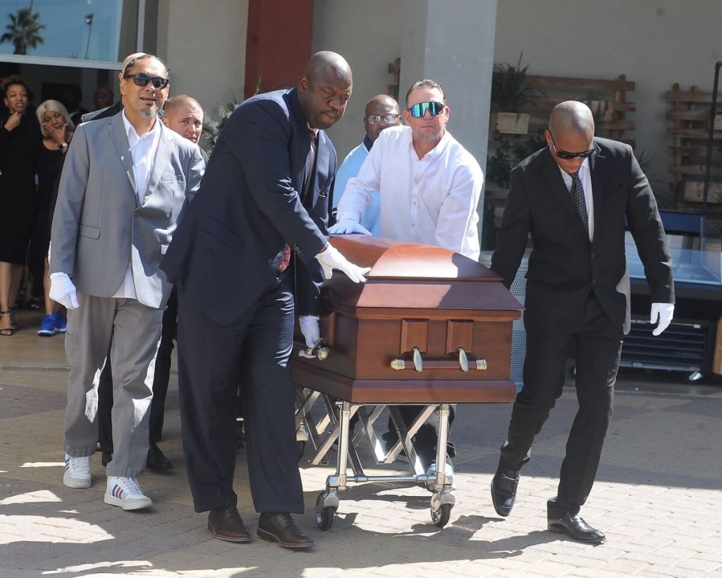 Don Johnson Sr. Pall bearers escort the casket of the late football coach Don Johnson, who passed away last month. Credit: Photo by Jerry Soifer