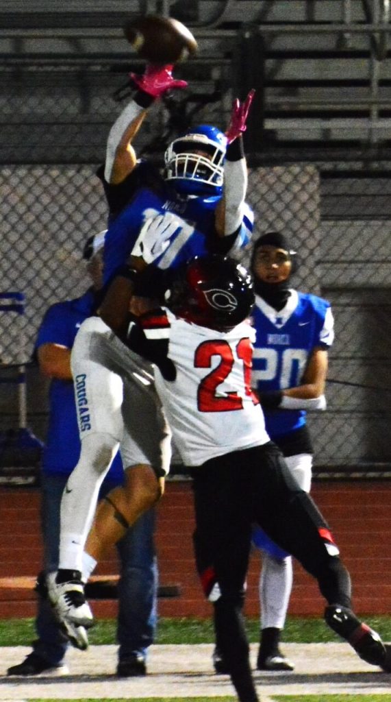 High School Sports Photos and Scoreboard for 10/28. Norco receiver Lincoln Longfellow (17) leaps high for a pass late in the game while Corona Centennial’s Carter Sweatt (21) defends. Photo By Gary Evans