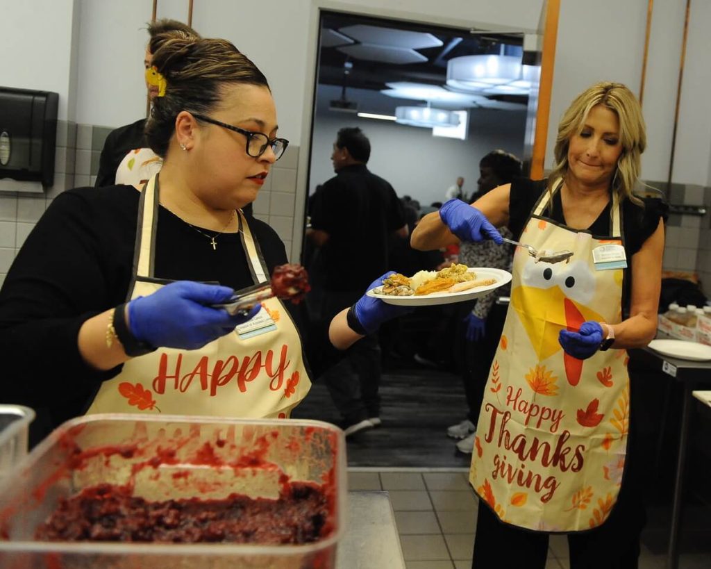 Senior Thanksgiving. Melissa Cervantes, left, and Melinda Stiwell prepare plates of turkey and dressing for about 200 men and women attending the Corona Senior Center Thanksgiving lunch at the Circle City Center. Credit: Photo by Jerry Soifer