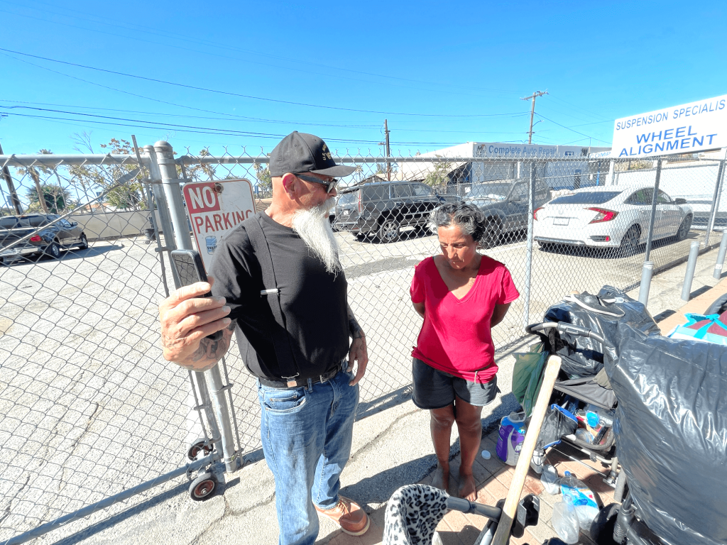 Chaplain Ed Moreno takes a selfie with Denise Bustamante, assuring her that he and American Legion Post 595 will help her with immediate needs. 
Credit: Photo by Don Ray
