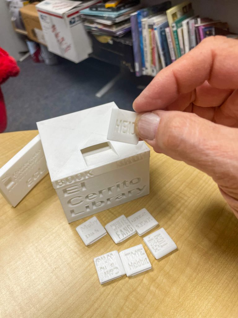 Selling oranges to purchase his own 3D printer, Brandon Flexman created a mini library drop-off box replete with book titles, for the El Cerrito Branch Library. Credit: Photo By Don Ray