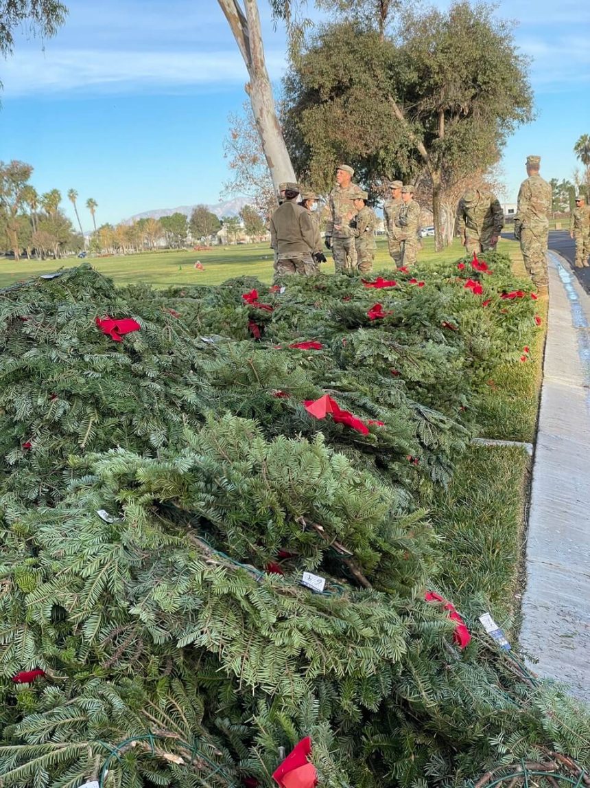 Army reservists and other volunteers arrived early on Saturday to unbox the truckloads of wreaths that volunteer truck drivers had dropped off on Friday. Credit: Photo by Don Ray
