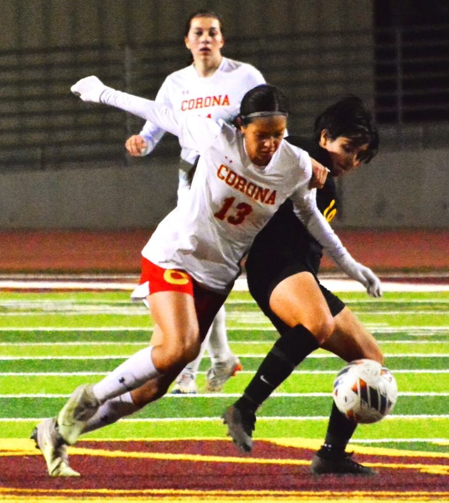Corona’s Giselle Fuentes (13) battles Hillcrest’s Jezabel Toledo (19) for the ball during the Trojans 3 – 1 victory over the Panthers.
