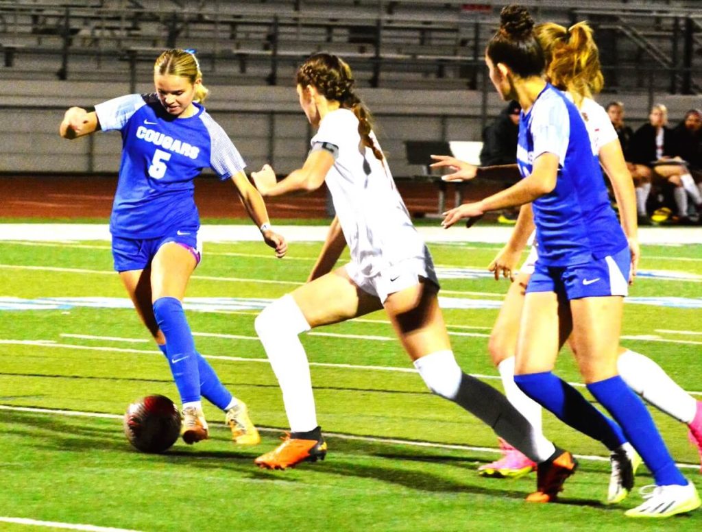 Norco’s Jaylin Young (left) gets a step Murrieta Valley’s Madison Ford (middle) on her way to scoring a goal that gave the Cougars a brief 3 -1 lead. The Nighthawks came back to tie Norco 3 – 3. Norco’s Anahi Hernandez (mid right) and Murrieta Valley’s Paisley Mclaughlin (right) watch the play.