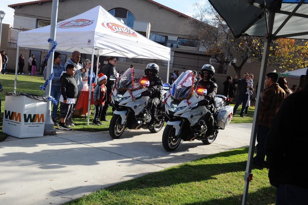 Corona Police motor officers escort Santa and Mrs. Claus to Saturday's Cops and Kids event at the Corona Civic Center.