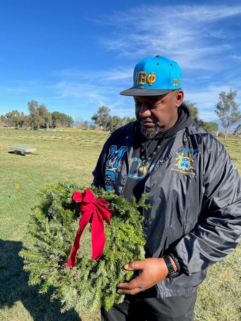 Retired Army 1st SGT Kevin Lamar Wheeler picked a special wreath to place next to the grave of his grandfather, Army 1st Sgt. Grover Bookman. Credit: Photo by Don Ray