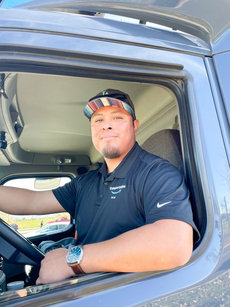 Amazon's "Employ of the Month," driver Bryan Miza, volunteered to deliver thousands of wreaths to the Riverside National Cemetery on Friday for the "Wreaths Across America" event on Saturday. Credit: Photo by Don Ray