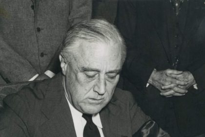 December 8. President Franklin D. Roosevelt is shown in the Oval Office signing the Congressional declaration of war against Japan on December 8, 1941.