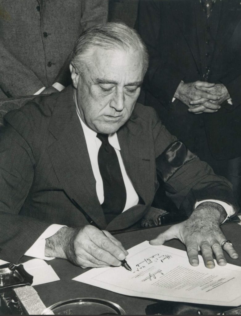 December 8. President Franklin D. Roosevelt is shown in the Oval Office signing the Congressional declaration of war against Japan on December 8, 1941. 
