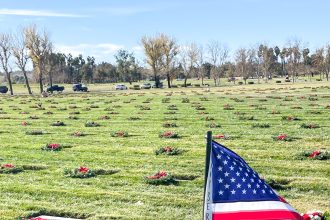 National Wreaths Across America Day. Caption: Volunteers from all walks of life placed holiday wreaths on the graves of veterans resting at the Riverside National Cemetery. Credit: Photo by Don Ray